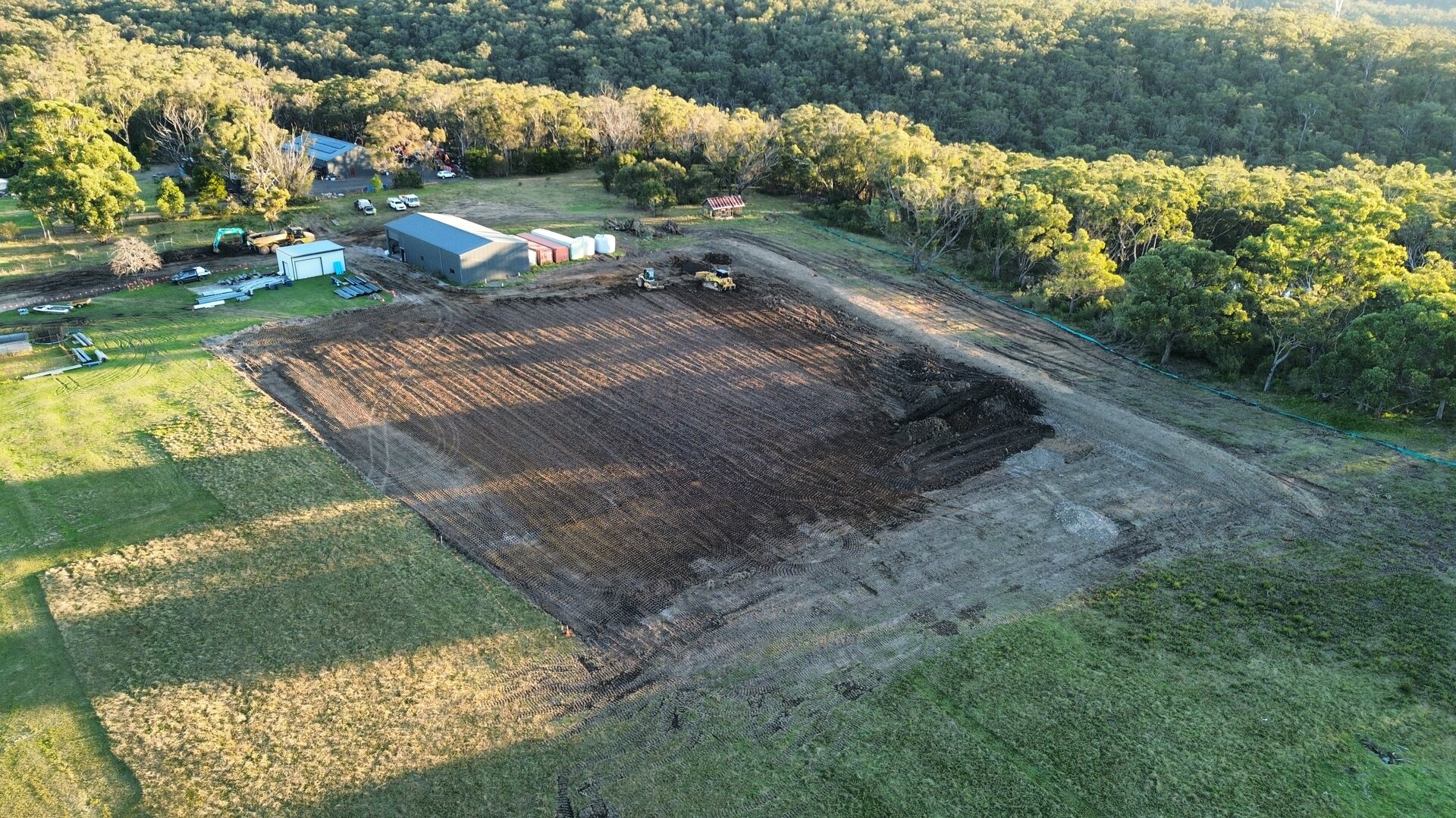 Dozer, articulated dump truck and padfoot roller working across the Buxton site