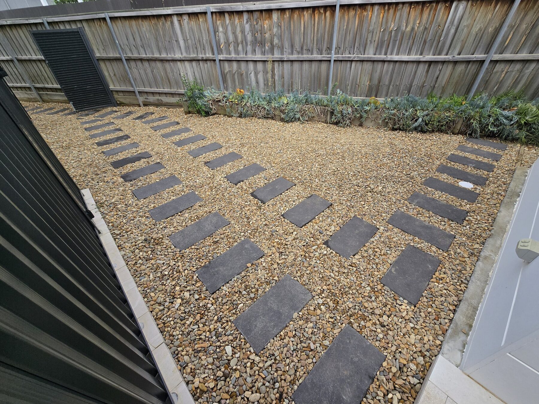 Completed gravel side access with large-format stepping stones