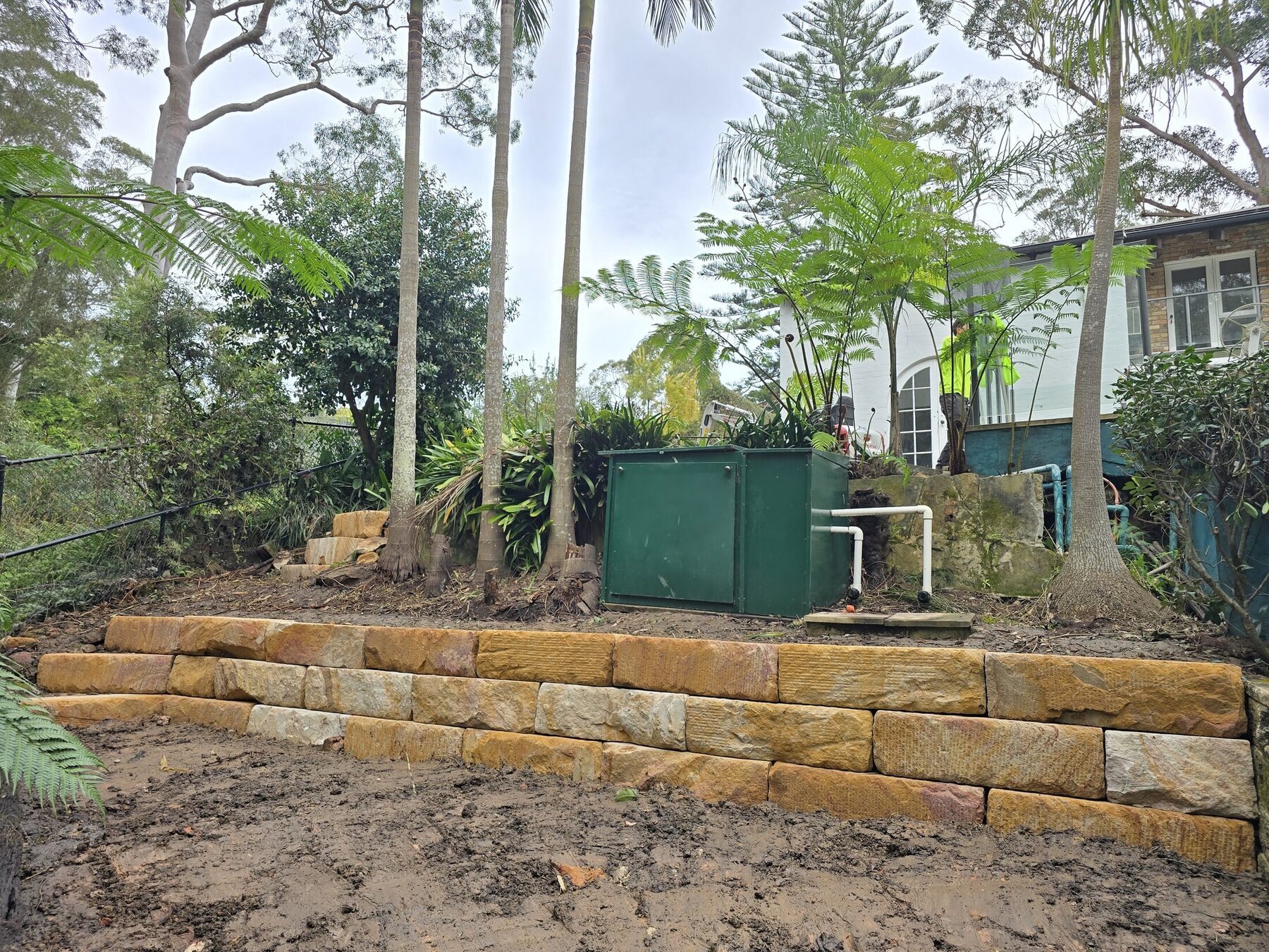 Completed natural sandstone retaining wall by Moores Trades and Services