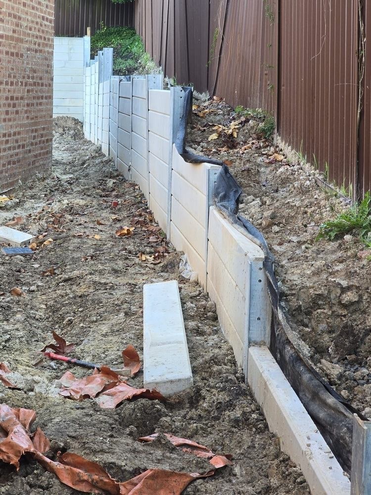 Unsafe retaining-wall installation completed by another contractor