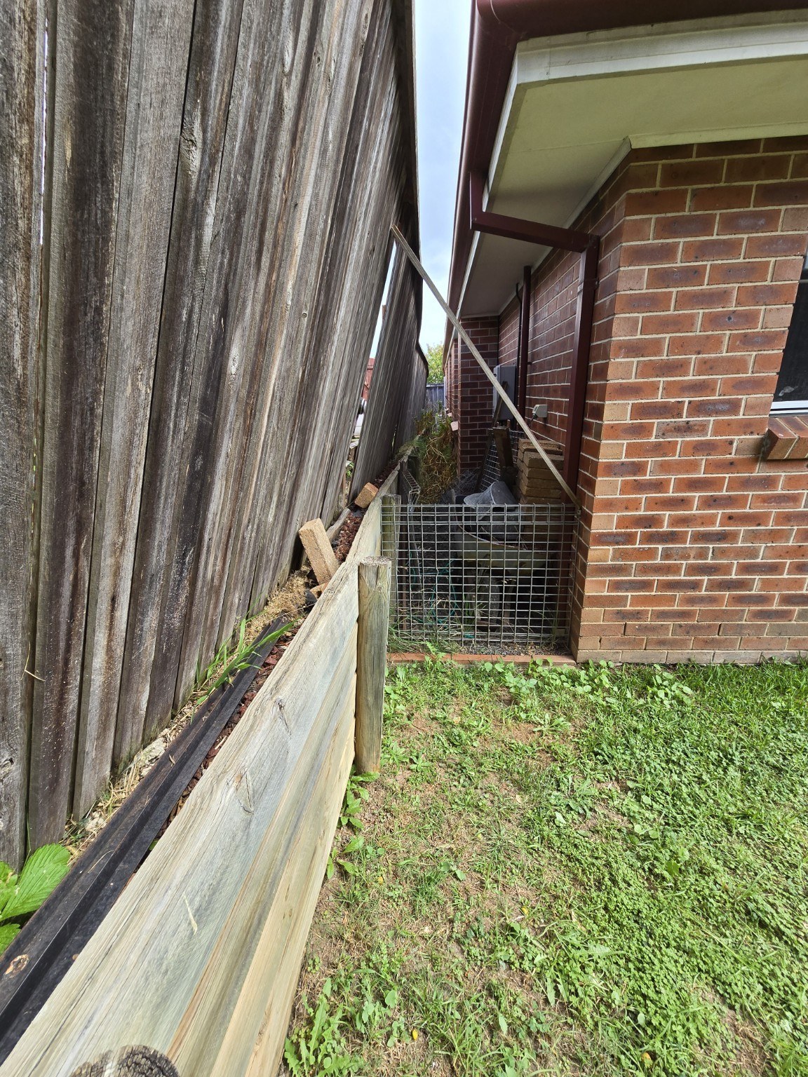 Failed wall and fence in the narrow side access